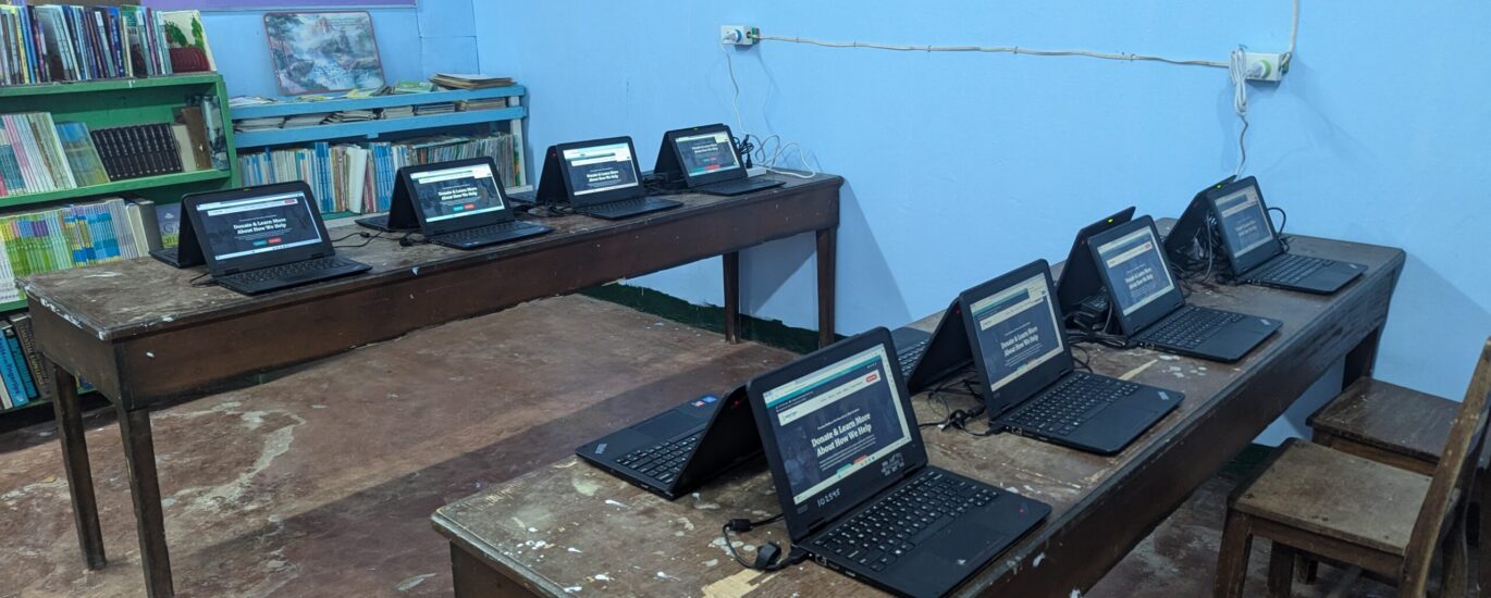 Laptop computers installed and ready for student use in a community classroom