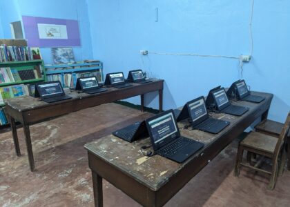 Laptop computers installed and ready for student use in a community classroom