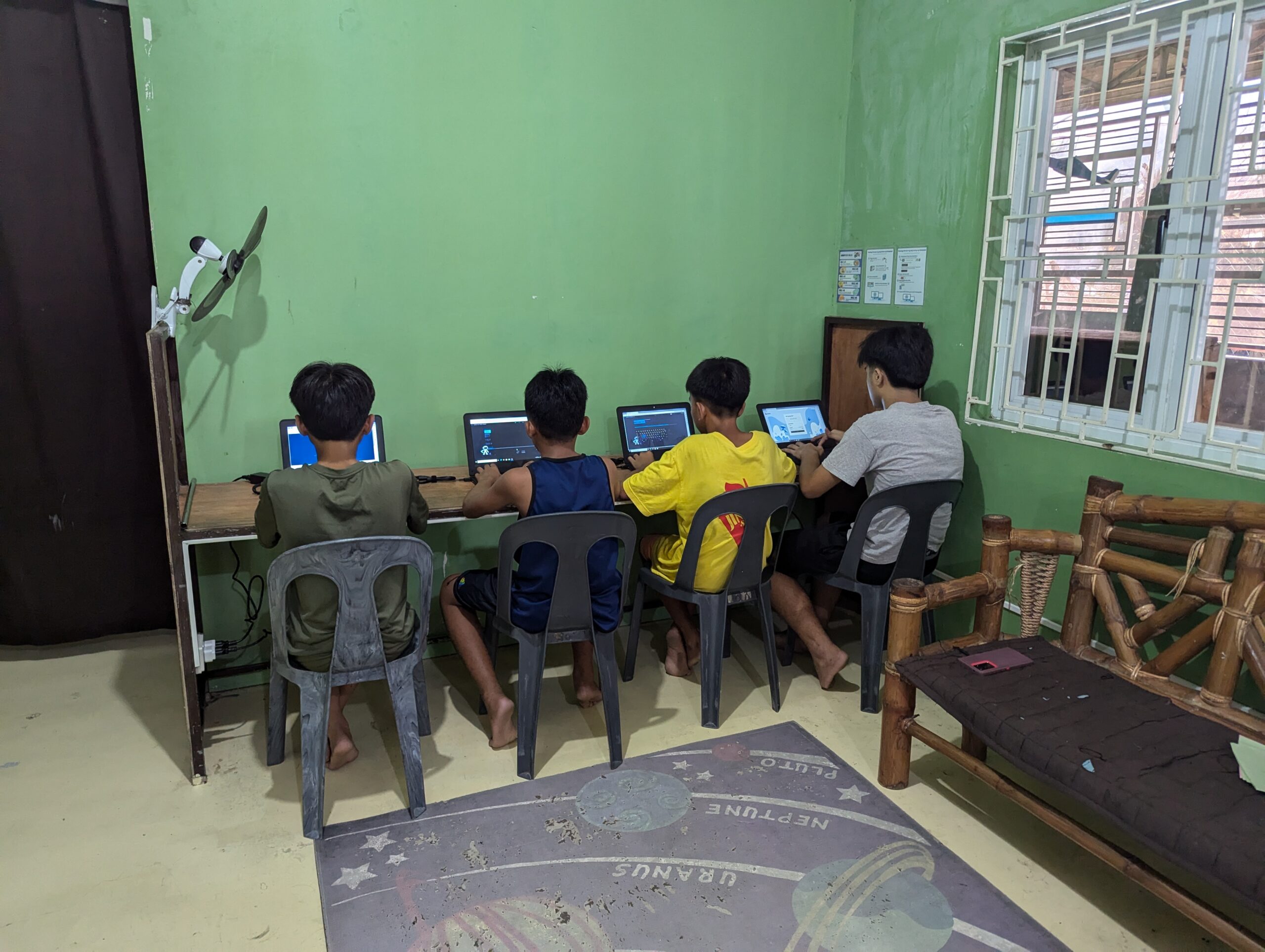 Students using donated laptop computers during a community technology program